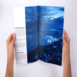 手持A4大小杂志内页版式设计打开效果图样机 Holding A4 Magazine Opened Mockup